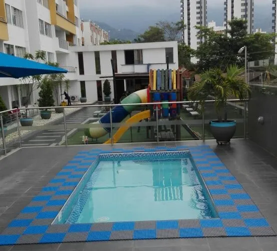 Blue and grey anti-slip tiles surrounding a small pool